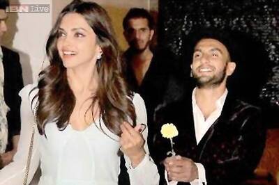 Smitten much? Flower in hand, Ranveer Singh follows Deepika Padukone as they exit Farah Khan's birthday party