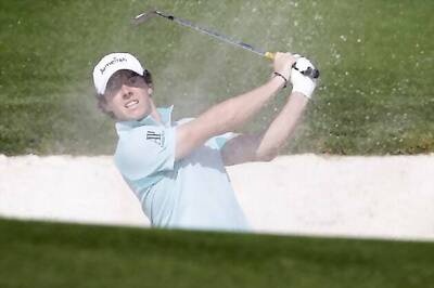 Rory McIlroy retains Dubai lead, Tiger Woods toils